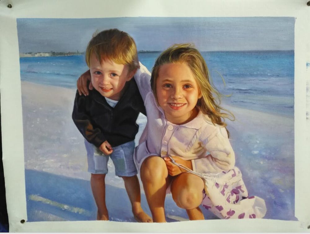  Young brother and sister portrait painting on a beach. 